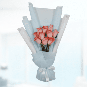 A vibrant bouquet of orange roses arranged elegantly, showcasing their lush petals and green foliage.