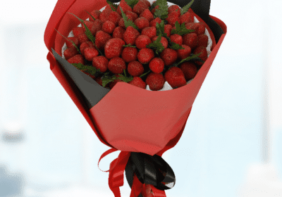 A vibrant bouquet of 101 fresh strawberries arranged beautifully, showcasing their bright red color and green leaves.