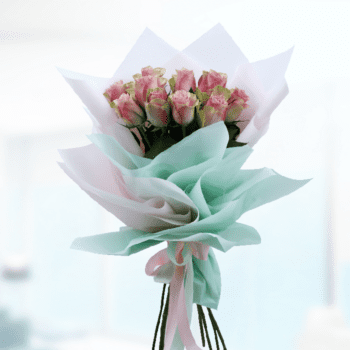 A vibrant bunch of Bellerose flowers, showcasing their delicate petals and rich colors against a neutral background.