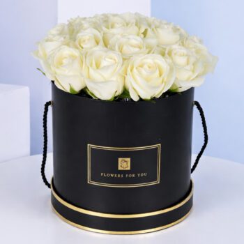 Elegant black hat box filled with 20 white roses, showcasing a sophisticated floral arrangement.