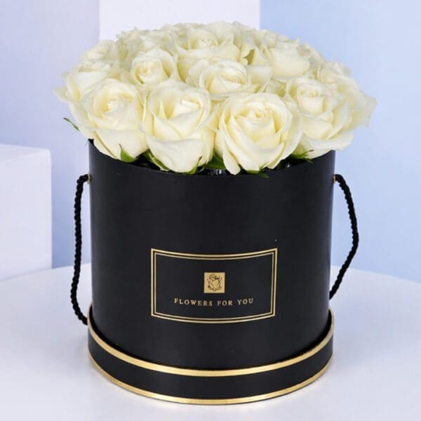 reverence-white-2026 Elegant black hat box filled with 20 white roses, showcasing a sophisticated floral arrangement.