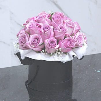 A special arrangement of purple roses in a decorative box, perfect for any occasion.