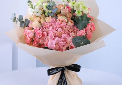 A lovely bouquet featuring a mix of exquisite pink flowers, elegantly arranged for a luxurious yet subtle appearance.