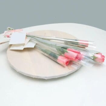 Single stem light pink rose with delicate petals and a green stem, symbolizing love and admiration.