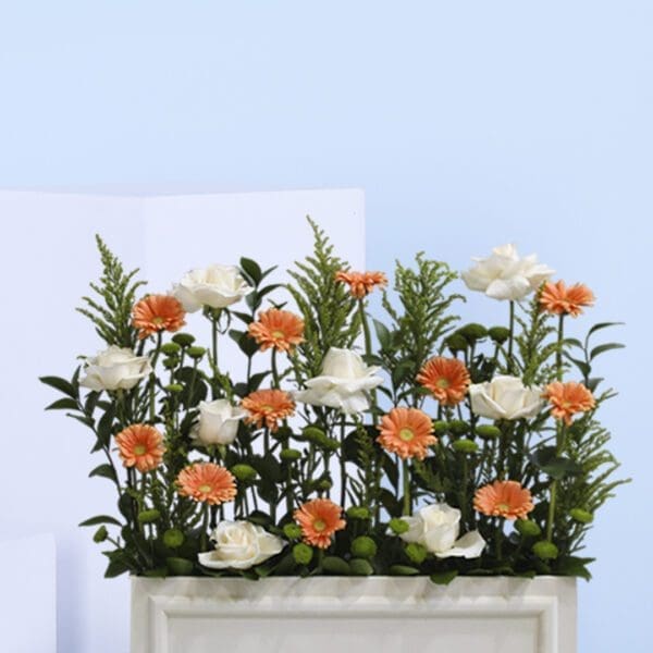 2 vibrant orange gerbera daisies and elegant white roses