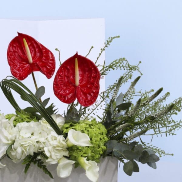 3 anthuriums, hydrangeas, lilies, and calla lilies.