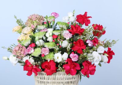 An elegant basket overflowing with fresh flowers, beautifully arranged to showcase the rich colours and textures of autumn.