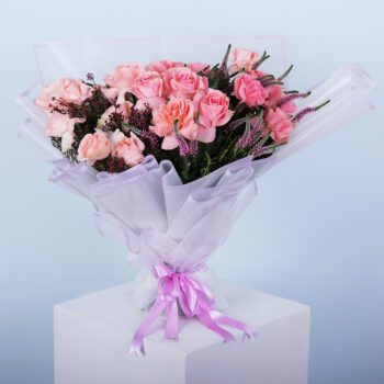 A bouquet featuring peach harmony roses, veronica stems, and colourful African flowers in an elegant arrangement.