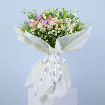 A beautiful bouquet of pink gerberas, pink roses, white ohara lilies, and other flowers.