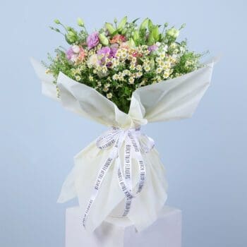 A beautiful bouquet of pink gerberas, pink roses, white ohara lilies, and other flowers.