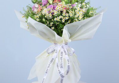 A beautiful bouquet of pink gerberas, pink roses, white ohara lilies, and other flowers.