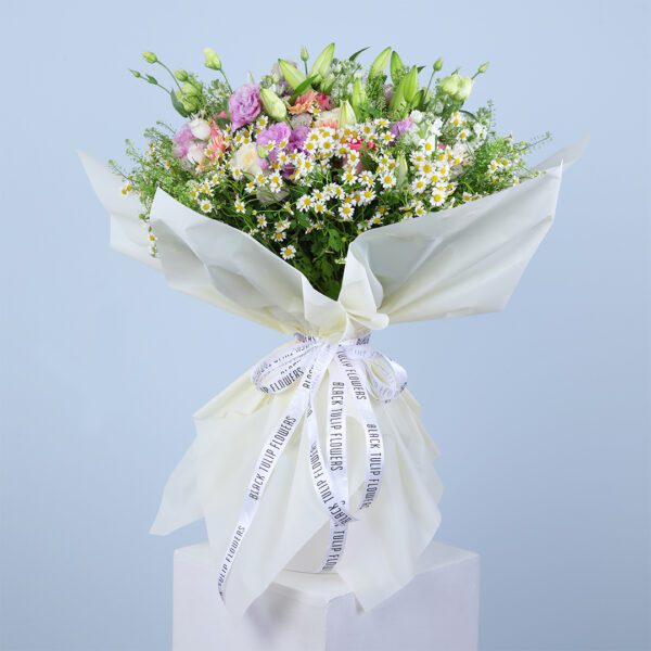 A beautiful bouquet of pink gerberas, pink roses, white ohara lilies, and other flowers.