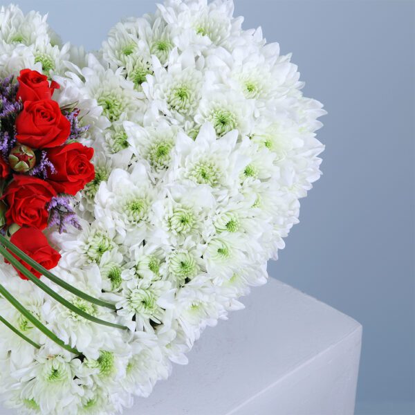 A heart-shaped arrangement of white and red flowers, ideal for anniversaries, Valentine's Day, or romantic gestures.