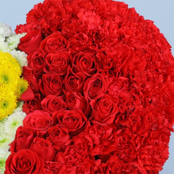 This heart-shaped design of white chrysanthemums and red carnations symbolizes unity—perfect for weddings or romantic events.