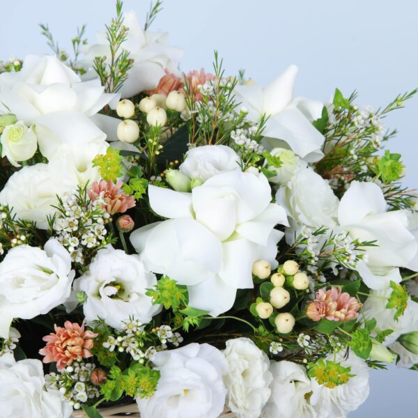 An elegant arrangement of white flowers in a basket, showing the beauty and floral sophistication.