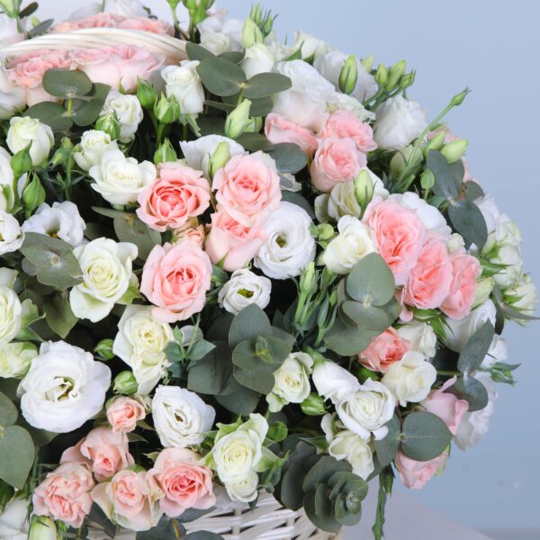 Elegant flower basket featuring soft pink Sweet Sara roses, white spray roses, and fresh eucalyptus.