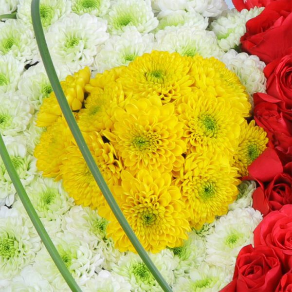 A heart-shaped arrangement of white chrysanthemums and red carnations, ideal for anniversaries or Valentine's Day.