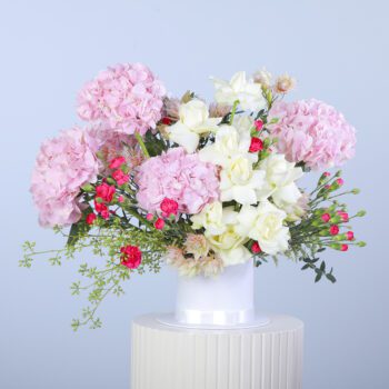 Beautiful bouquet of pink hydrangeas and white roses with fresh greenery.