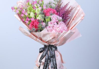 Vibrant mixed flower bouquet featuring a variety of seasonal blooms in bright colors.