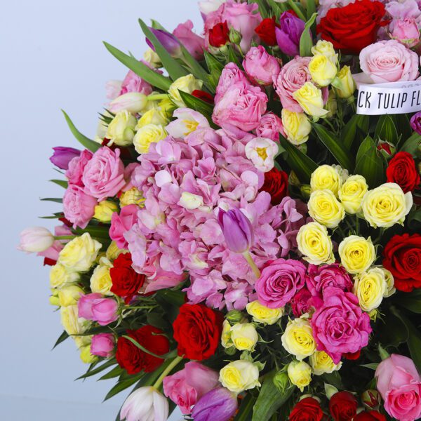 Vibrant Floral Arrangement in a Large Basket with Pink Hydrangeas, Roses, and Greenery