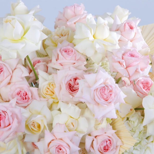 A beautiful arrangement of pink and white flowers elegantly presented in a pristine white box, creating a fresh and welcoming ambiance.