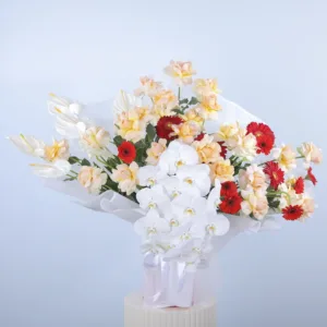 The image shows a large and elegant flower arrangement. It features a variety of flowers in different colors