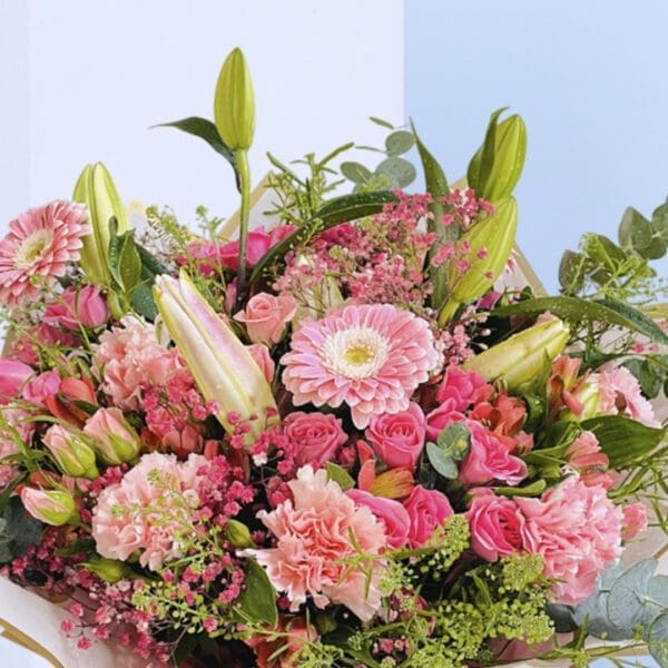4Pretty in Pink A beautiful bouquet of pink flowers tied up with a white ribbon.