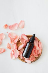 Rose petals and an oil bottle.