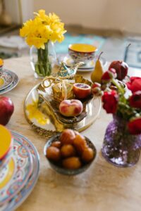 A round table with a light-colored surface (possibly marble or a similar material) serves as the base for the arrangement.