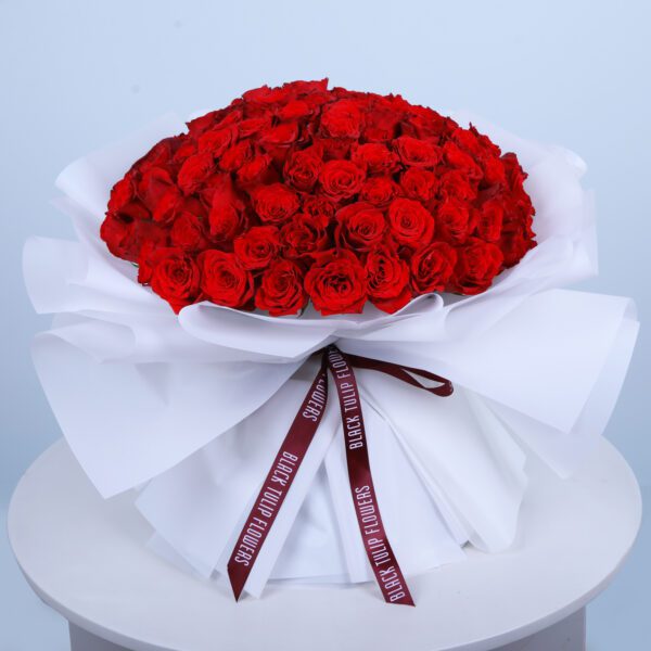 Experience our stunning red roses, wrapped in a soft, cloud-like white. A truly captivating gift.