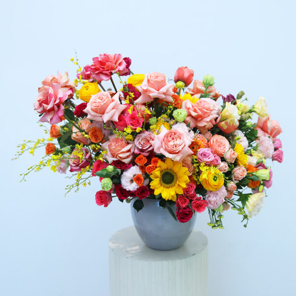 A vase filled with colorful flowers sits elegantly on a wooden table.