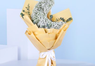 Half-moon floral arrangement featuring delicate white flowers.