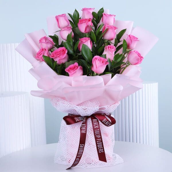 Pinky Charm A bouquet of fresh light pink roses wrapped in soft pink paper with a delicate ribbon.