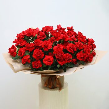 Bouquet of rich red roses wrapped in premium packaging, symbolizing deep love and grand celebrations.