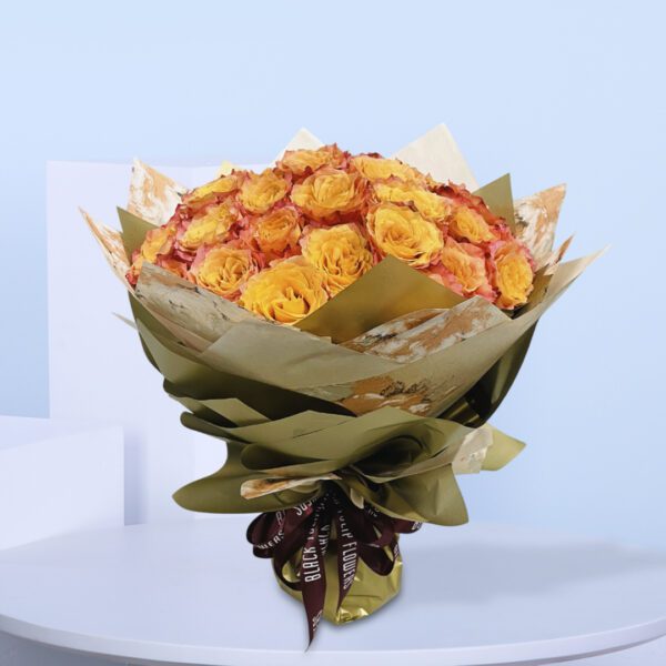 Golden-orange roses wrapped in gold and brown paper with a stylish ribbon.