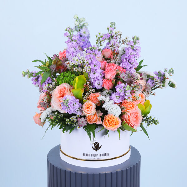 Decorative flower box filled with colorful seasonal blooms and greenery.