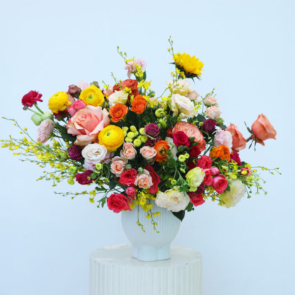 A vase filled with colorful flowers sits elegantly on a wooden table.