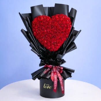 A bouquet of vibrant red roses arranged in a sleek black vase.