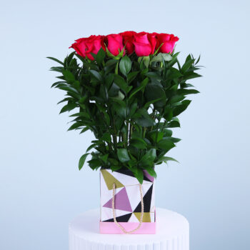 Stunning floral bag featuring fresh pink roses.