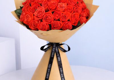 Classic bouquet of orange roses tied with a satin ribbon.