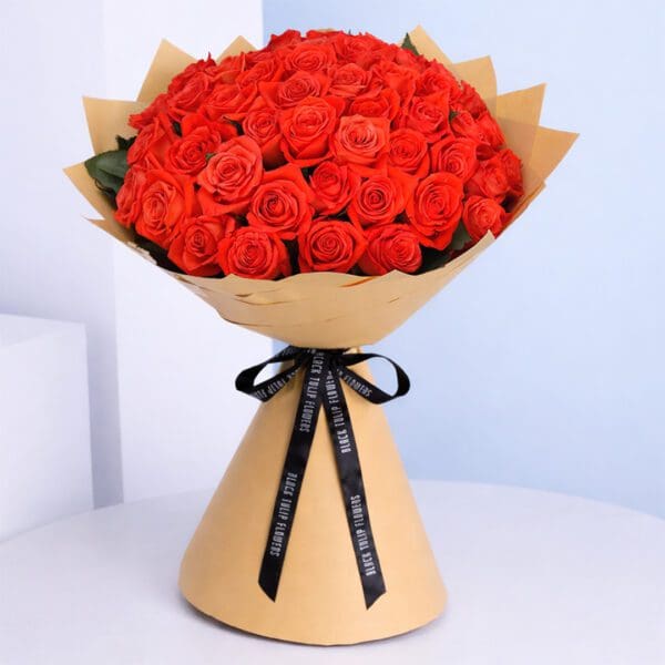 orange-rose-spritz_2026 Classic bouquet of orange roses tied with a satin ribbon.