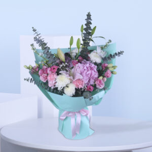 Delight in the elegance of soft pink, white, and lush greenery wrapped in a refreshing aqua blue wrap—perfect for every heartfelt occasion.