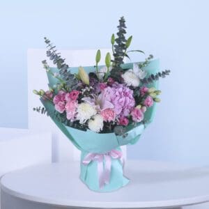 Delight in the elegance of soft pink, white, and lush greenery wrapped in a refreshing aqua blue wrap—perfect for every heartfelt occasion.