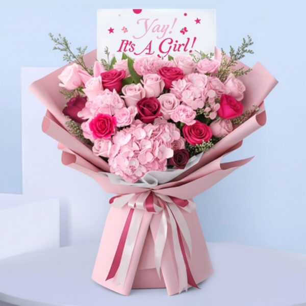 Pink baby girl bouquet with roses, hydrangeas, carnations, and “It’s a Girl” card.