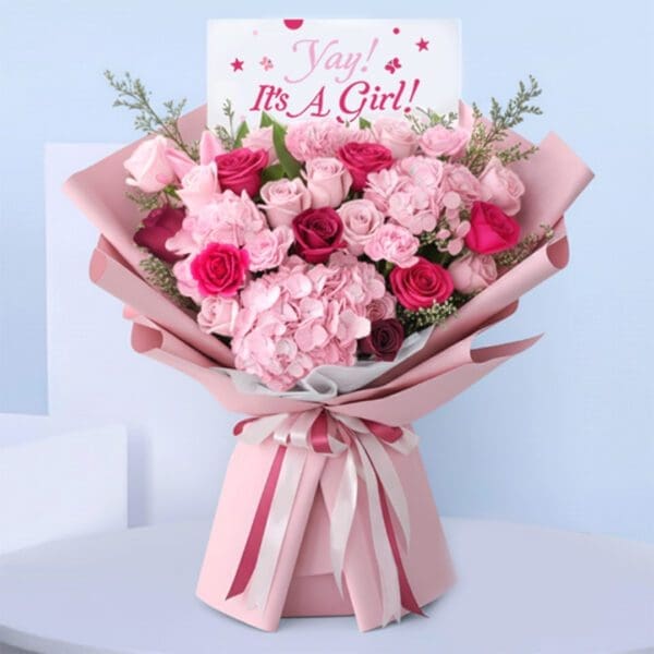 baby-girl-bouquet-pink. Pink baby girl bouquet with roses, hydrangeas, carnations, and “It’s a Girl” card.