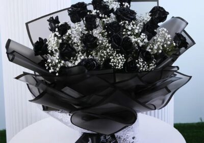 Black painted roses with baby’s breath in black luxury wrapping.