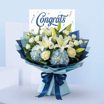 Congrats bouquet with lilies, white roses, blue hydrangeas, and blue wrapping with ribbon.