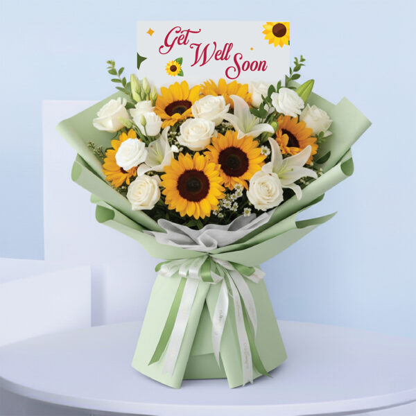 get-well-sunflower-bouquet Bouquet featuring hand-tied sunflowers, white roses & lilies in pastel green wrap, finished with a “Get Well Soon” card.