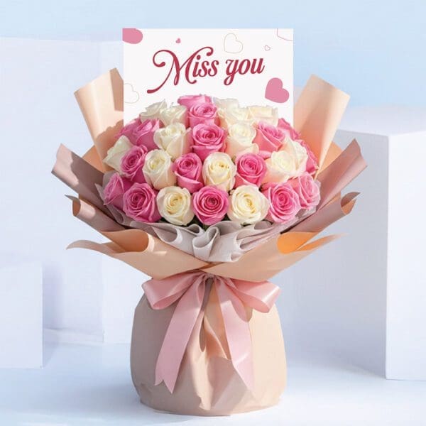 miss-you-bouquet-roses. Bouquet featuring hand-tied pink roses & white roses in pastel wrap, finished with a “Miss You” card.