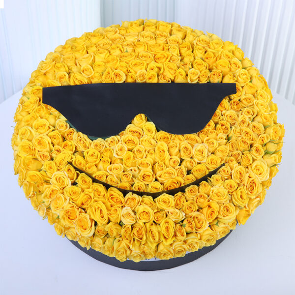 Yellow spray roses arranged in a cool sunglasses smiley-face floral box design.